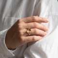 Woman wearing the Baltic Honey Amber Ring in Sterling Silver, showcasing genuine honey Baltic amber and polished 925 sterling silver in an elegant luxury jewelry lifestyle setting.