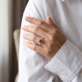Woman wearing the Baltic Honey Amber Ring in Sterling Silver, showcasing genuine honey Baltic amber and polished 925 sterling silver in an elegant luxury jewelry lifestyle setting.