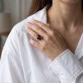Woman wearing the Dana Cherry Baltic Amber Ring in Sterling Silver, showcasing genuine cherry Baltic amber and polished 925 sterling silver in an elegant luxury jewelry lifestyle setting.