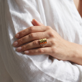 Woman wearing the Klaudia Multicolor Baltic Amber Ring in Sterling Silver, showcasing genuine multicolor Baltic amber and polished 925 sterling silver in an elegant luxury jewelry lifestyle setting.