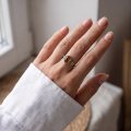 Woman wearing the Mirela Baltic Honey Amber Ring in Sterling Silver, showcasing genuine honey Baltic amber and polished 925 sterling silver in an elegant luxury jewelry lifestyle setting.