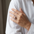 Woman wearing the Ruth Baltic Honey Amber Square Ring in Sterling Silver, showcasing genuine honey Baltic amber and polished 925 sterling silver in an elegant luxury jewelry lifestyle setting.