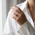Woman wearing the Sunniva Baltic Honey Amber Rectangular Ring in Sterling Silver, showcasing genuine honey Baltic amber and polished 925 sterling silver in an elegant luxury jewelry lifestyle setting.