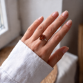 Woman wearing the Baltic Amber Rose Flower Ring in Sterling Silver, showcasing genuine Baltic amber and polished 925 sterling silver in an elegant luxury jewelry lifestyle setting.