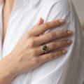 Woman wearing the Baltic Green Amber Celtic Knot Ring in Sterling Silver, showcasing genuine green Baltic amber and polished 925 sterling silver in an elegant luxury jewelry lifestyle setting.