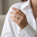 Woman wearing the Baltic Green Amber Claddagh Ring in Sterling Silver, showcasing genuine green Baltic amber and polished 925 sterling silver in an elegant luxury jewelry lifestyle setting.