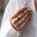 Woman wearing the Baltic Green Amber Ring in Sterling Silver, showcasing genuine green Baltic amber and polished 925 sterling silver in an elegant luxury jewelry lifestyle setting.