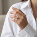 Woman wearing the Baltic Honey Amber Claddagh Ring in Sterling Silver, showcasing genuine honey Baltic amber and polished 925 sterling silver in an elegant luxury jewelry lifestyle setting.