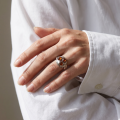 Woman wearing the Baltic Honey Amber Infinity Ring in Sterling Silver, showcasing genuine honey Baltic amber and polished 925 sterling silver in an elegant luxury jewelry lifestyle setting.Woman wearing the Baltic Honey Amber Infinity Ring in Sterling Silver, showcasing genuine honey Baltic amber and polished 925 sterling silver in an elegant luxury jewelry lifestyle setting.