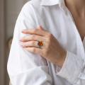 Woman wearing the Baltic Honey Amber Oval Ring in Sterling Silver, showcasing genuine honey Baltic amber and polished 925 sterling silver in an elegant luxury jewelry lifestyle setting.