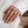 Woman wearing the Baltic Honey Amber Pear-Shaped Ring in Sterling Silver, showcasing genuine honey Baltic amber and polished 925 sterling silver in an elegant luxury jewelry lifestyle setting.