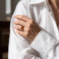 Woman wearing the Baltic Honey Amber Ring in Gold-Plated Sterling Silver, showcasing genuine honey Baltic amber and polished gold-plated 925 sterling silver in an elegant luxury jewelry lifestyle setting.