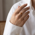 Woman wearing the Baltic Honey Amber Square Ring in Gold-Plated Sterling Silver, showcasing genuine honey Baltic amber and polished gold-plated 925 sterling silver in an elegant luxury jewelry lifestyle setting.