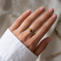 Woman wearing the Multicolor Baltic Amber Ring in Sterling Silver, showcasing genuine multicolor Baltic amber and polished 925 sterling silver in an elegant luxury jewelry lifestyle setting.