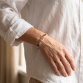Woman wearing the Autumn Baltic Amber Bracelet in Sterling Silver, showcasing genuine Baltic amber gemstones and polished 925 sterling silver in an elegant luxury jewelry lifestyle setting.