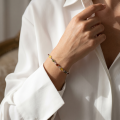 Woman wearing the Baltic Amber Bracelet in Sterling Silver, showcasing genuine Baltic amber gemstones and polished 925 sterling silver in an elegant luxury jewelry lifestyle setting.