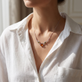 Woman wearing the Multicolor Baltic Amber Heart Necklace in Sterling Silver, showcasing genuine multicolor Baltic amber gemstones and polished 925 sterling silver in an elegant luxury jewelry lifestyle setting.