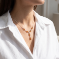 Woman wearing the Maja Baltic Honey Amber Necklace in Sterling Silver, showcasing genuine honey Baltic amber and polished 925 sterling silver in an elegant luxury jewelry lifestyle setting.