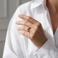 Woman wearing the Aria Baltic Honey Amber Ring in Sterling Silver, showcasing genuine honey Baltic amber and polished 925 sterling silver in an elegant luxury jewelry lifestyle setting.