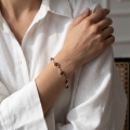 Woman wearing the Adriana Baltic Honey Amber Bracelet in Sterling Silver, showcasing genuine honey Baltic amber gemstones and polished 925 sterling silver in an elegant luxury jewelry lifestyle setting.