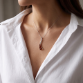 Woman wearing the Gabriela Baltic Amber Pendant in Sterling Silver, showcasing genuine Baltic amber and polished 925 sterling silver in an elegant luxury jewelry lifestyle setting.