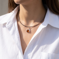 Woman wearing the Lauren Baltic Honey Amber Necklace in Sterling Silver, showcasing genuine honey Baltic amber and polished 925 sterling silver in an elegant luxury jewelry lifestyle setting.