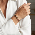 Woman wearing the Multicolor Baltic Amber Bracelet in Sterling Silver, showcasing genuine multicolor Baltic amber gemstones and polished 925 sterling silver in an elegant luxury jewelry lifestyle setting.
