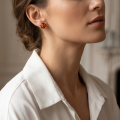 Woman wearing the Baltic Honey Amber Round Stud Earrings in Sterling Silver, showcasing genuine round honey Baltic amber gemstones and polished 925 sterling silver in an elegant luxury jewelry lifestyle setting.
