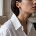 Woman wearing the Baltic Honey Amber Square Stud Earrings in Sterling Silver, showcasing genuine square-shaped honey Baltic amber gemstones and polished 925 sterling silver in an elegant luxury jewelry lifestyle setting.