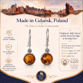 Stephanie Baltic Honey Amber Drop Earrings in Sterling Silver infographic highlighting authentic honey Baltic amber, 925 sterling silver, drop earring design, handcrafted craftsmanship, earring dimensions, and Made in Gdańsk, Poland heritage.