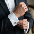 Man wearing the Ship Steering Wheel Baltic Honey Amber Cufflinks in Sterling Silver, showcasing genuine honey Baltic amber gemstones and polished 925 sterling silver in an elegant luxury jewelry lifestyle setting.