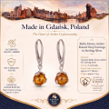 Baltic Honey Amber Round Drop Earrings in Sterling Silver infographic highlighting authentic honey Baltic amber, 925 sterling silver, round drop design, handcrafted craftsmanship, earring dimensions, and Made in Gdańsk, Poland heritage.
