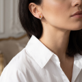 Close-up of a model wearing a “Nelia” Baltic Honey Amber earring in sterling silver.