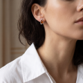 Close-up of a model wearing a “Hailee” Baltic Honey Amber Stud Earring.