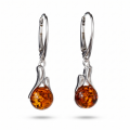 Pair of “Melanie” Baltic Honey Amber Round Drop Earrings in Sterling Silver on a white background.