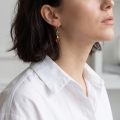Close-up of a model wearing a Baltic Honey Amber Drop Earring in Sterling Silver.