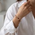Close-up of the “Blossom” Baltic Honey Amber Bracelet worn on a wrist.