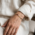 Close-up of the “Alexa” Multicolor Baltic Amber Bracelet worn on a wrist.