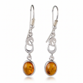 Pair of “Amalie” Baltic Honey Amber Drop Earrings in Sterling Silver on a white background.