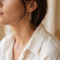 Close-up of a model wearing an “Alvina” Baltic Honey Amber Drop Earring.