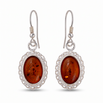 Pair of “Cecilie” Baltic Honey Amber Earrings in Sterling Silver on a white background, featuring oval amber stones and ornate silver settings.