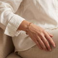 Baltic Honey Amber Heart Hearts Bracelet in Sterling Silver worn on a model’s wrist, shown in a close-up view.