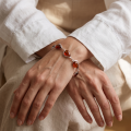 “Adele” Baltic Honey Amber Bracelet in Sterling Silver worn on a model’s wrist, shown in a close-up view.