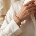 “Frogs” Multicolor Baltic Amber Bracelet in Sterling Silver worn on a model’s wrist, shown in a close-up view.