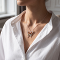 “Butterfly” Multicolor Baltic Amber Pendant in Sterling Silver worn on a chain, shown in a close-up view of the neck and collarbone.