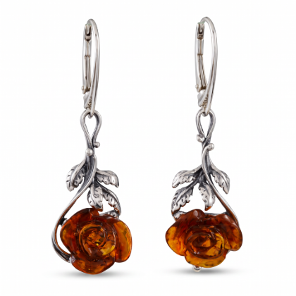 “Open Rose” Baltic Honey Amber Drop Earrings in Sterling Silver worn by a model, shown in a close-up view of the ear.