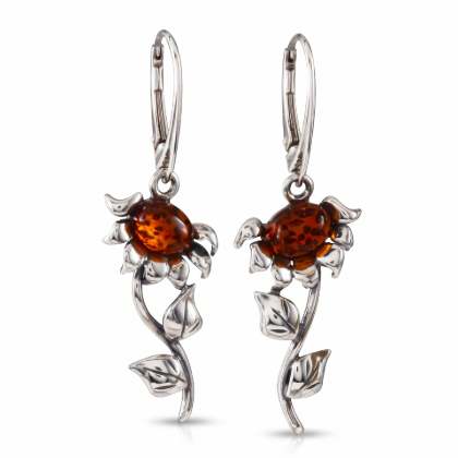 Baltic Honey Amber Sunflower Drop Earrings in Sterling Silver worn by a model, shown in a close-up view of the ear.