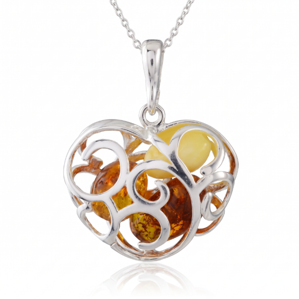 Baltic Amber Heart Pendant in Sterling Silver worn on a chain, shown in a close-up view of the neck and collarbone.